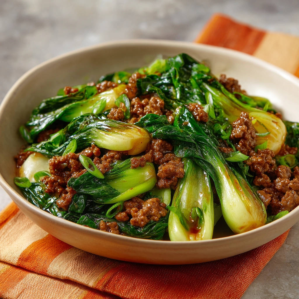 Beef and bok choy stir-fry served in a rustic bowl, presented from a close-up overhead perspective.