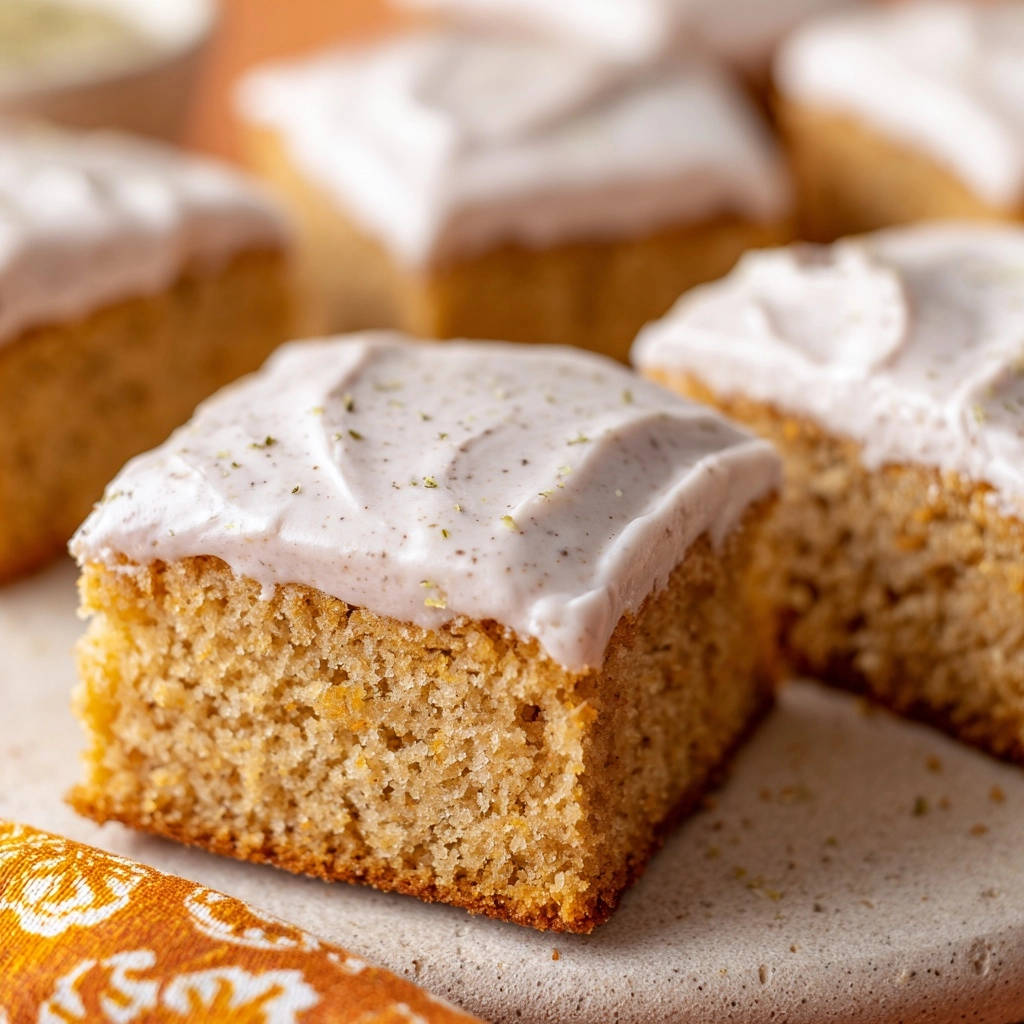 Lemon Lavender Sheet Cake: a close-up view of a frosted slice showing the tender cake crumb and delicate garnish.